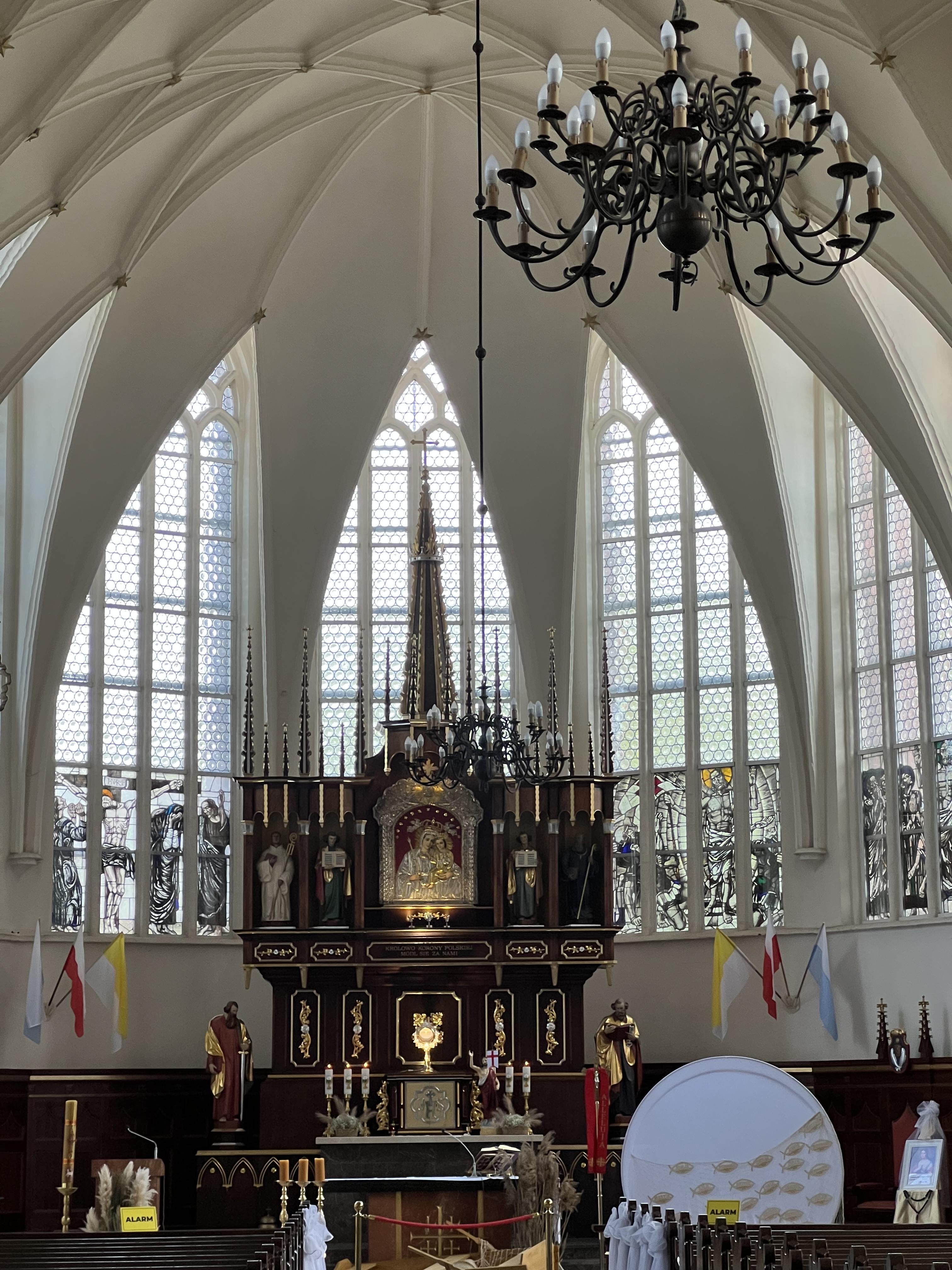 Oliwa Cathedral — white vaults pulling the eye up to a dark-and-gold altar.
